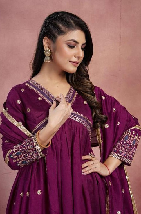 Women Anarkali kurta , pant with heavy dupatta.