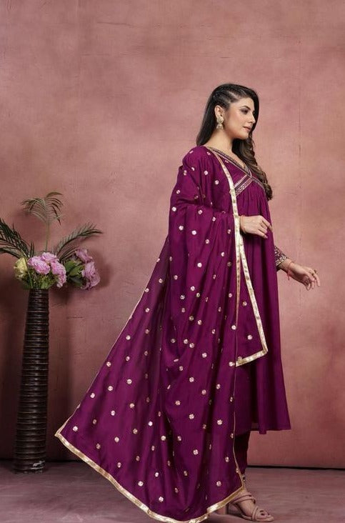 Women Anarkali kurta , pant with heavy dupatta.